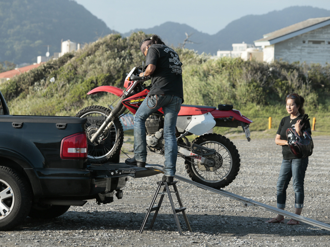 ▲時には自らバイクを運転しながら撮影することもあるという。仕事、プライベートに関わらずバイクは欠かせない道具。荷台に乗せるのは250ccのホンダ XR250